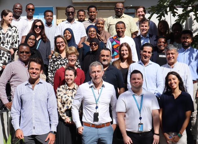 UNAA and WFP Somalia staff standing together outside posing for a photo